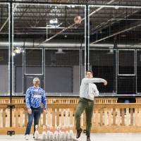 An alumnus throwing a football at the Fowling Fun Event